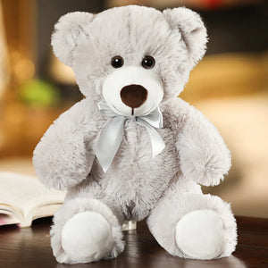 plush teddy bear wearing a bow tie