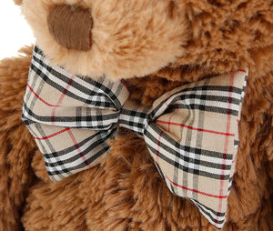 soft teddy bear wearing a bow tie