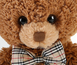 soft teddy bear wearing a bow tie